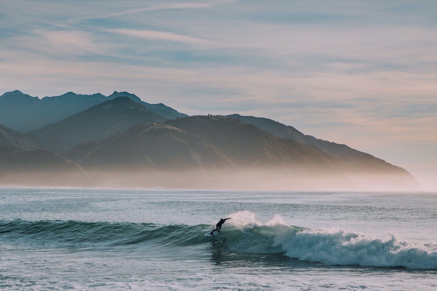 Surf riding a fun wave in New Zealand